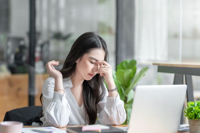 Tired woman at a laptop